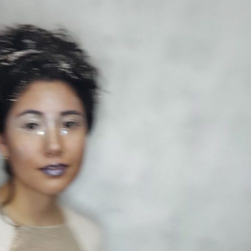 Blur photo of a woman in dark lipstick.