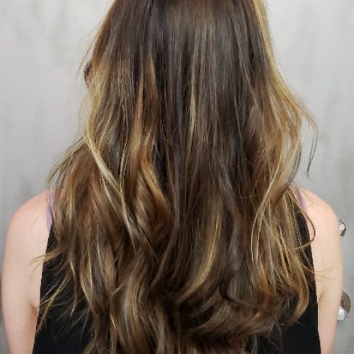 Back view of a woman's curly long hair.